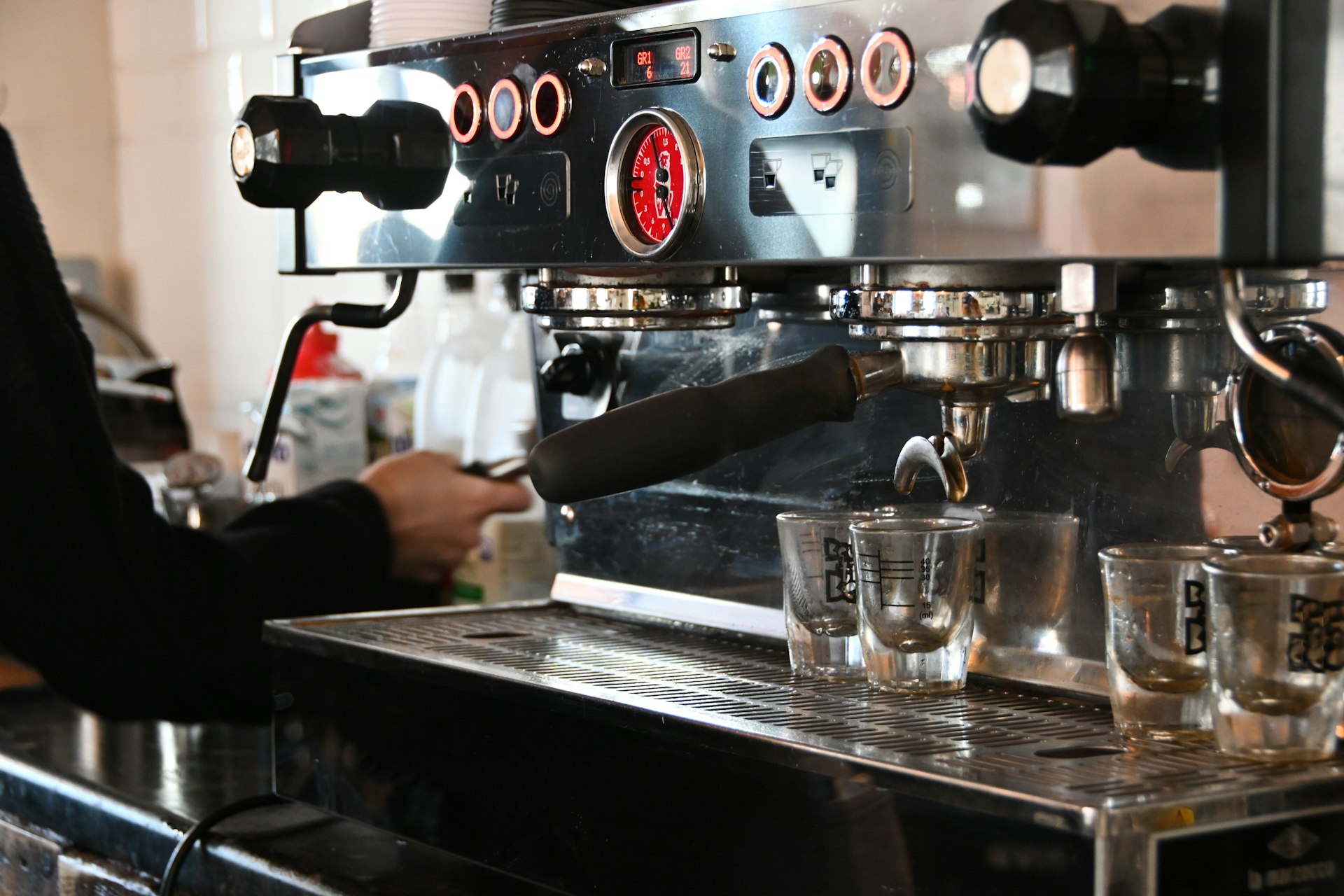 a person pouring a drink into a glass